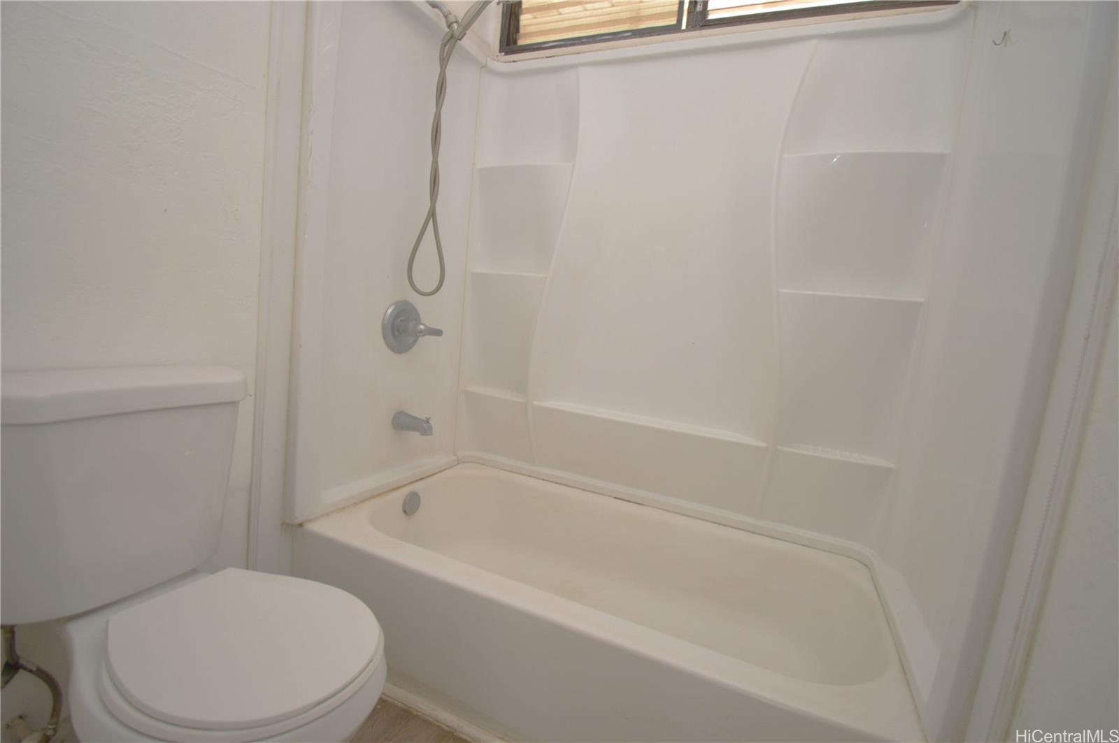 87-21317 Helelua Place, Unit 7 Waianae, HI 96792 - Photo 16 of 21 a bathroom with a toilet and a bath tub
