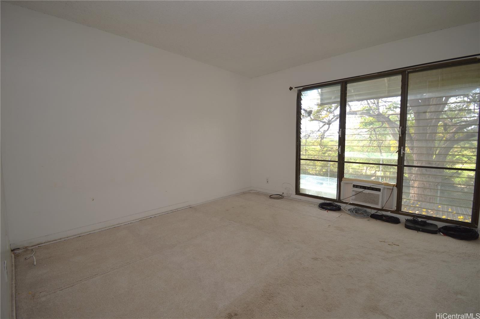87-21317 Helelua Place, Unit 7 Waianae, HI 96792 - Photo 18 of 21 a view of an empty room with a sliding door