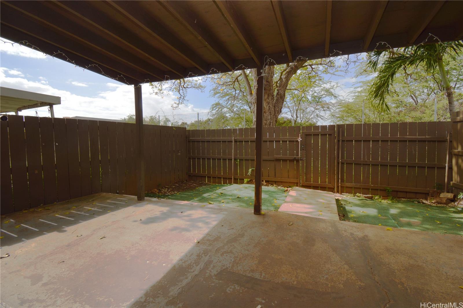 87-21317 Helelua Place, Unit 7 Waianae, HI 96792 - Photo 4 of 21 a view of backyard with wooden fence