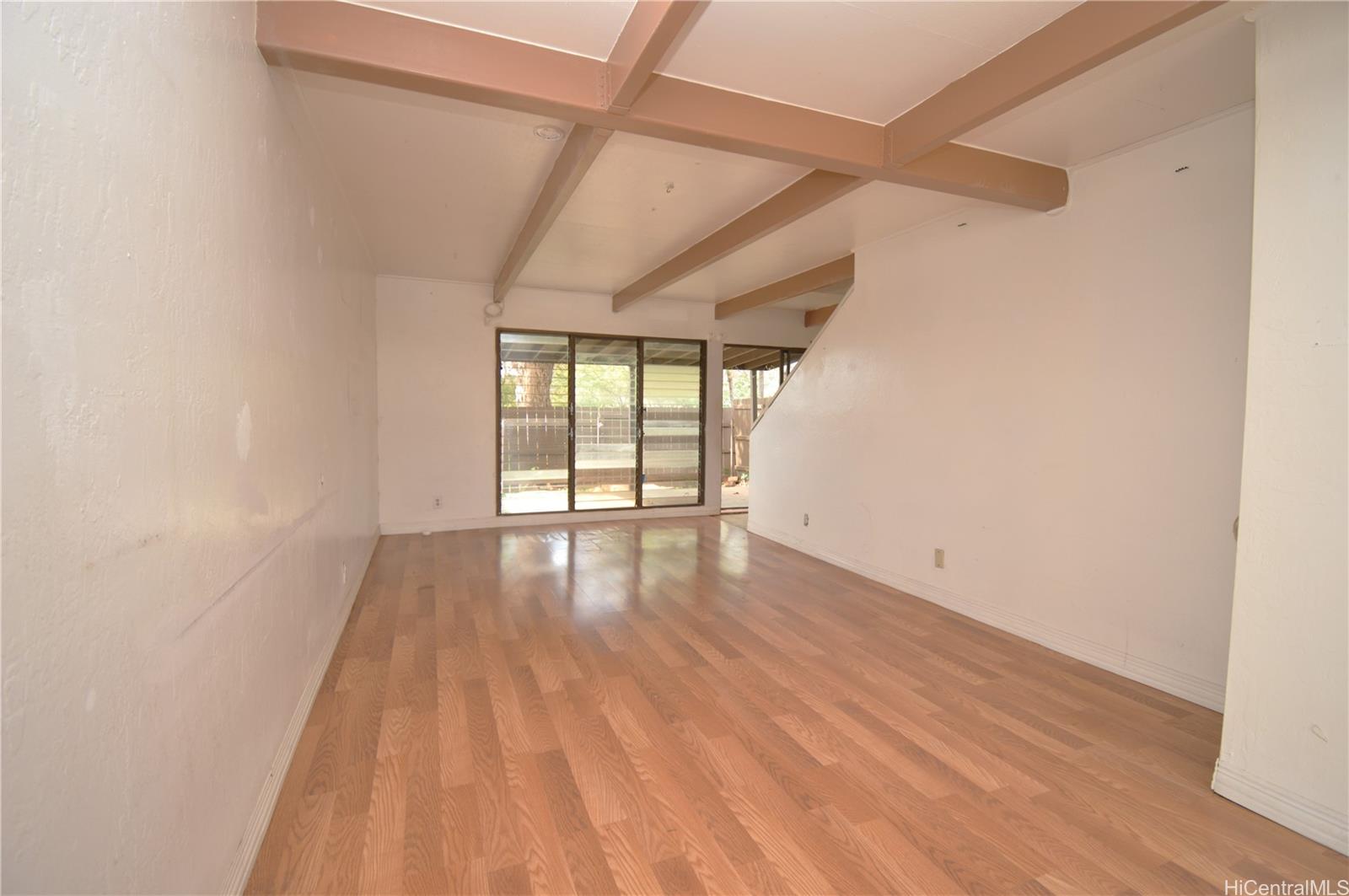 87-21317 Helelua Place, Unit 7 Waianae, HI 96792 - Photo 7 of 21 a view of an empty room with wooden floor and a window
