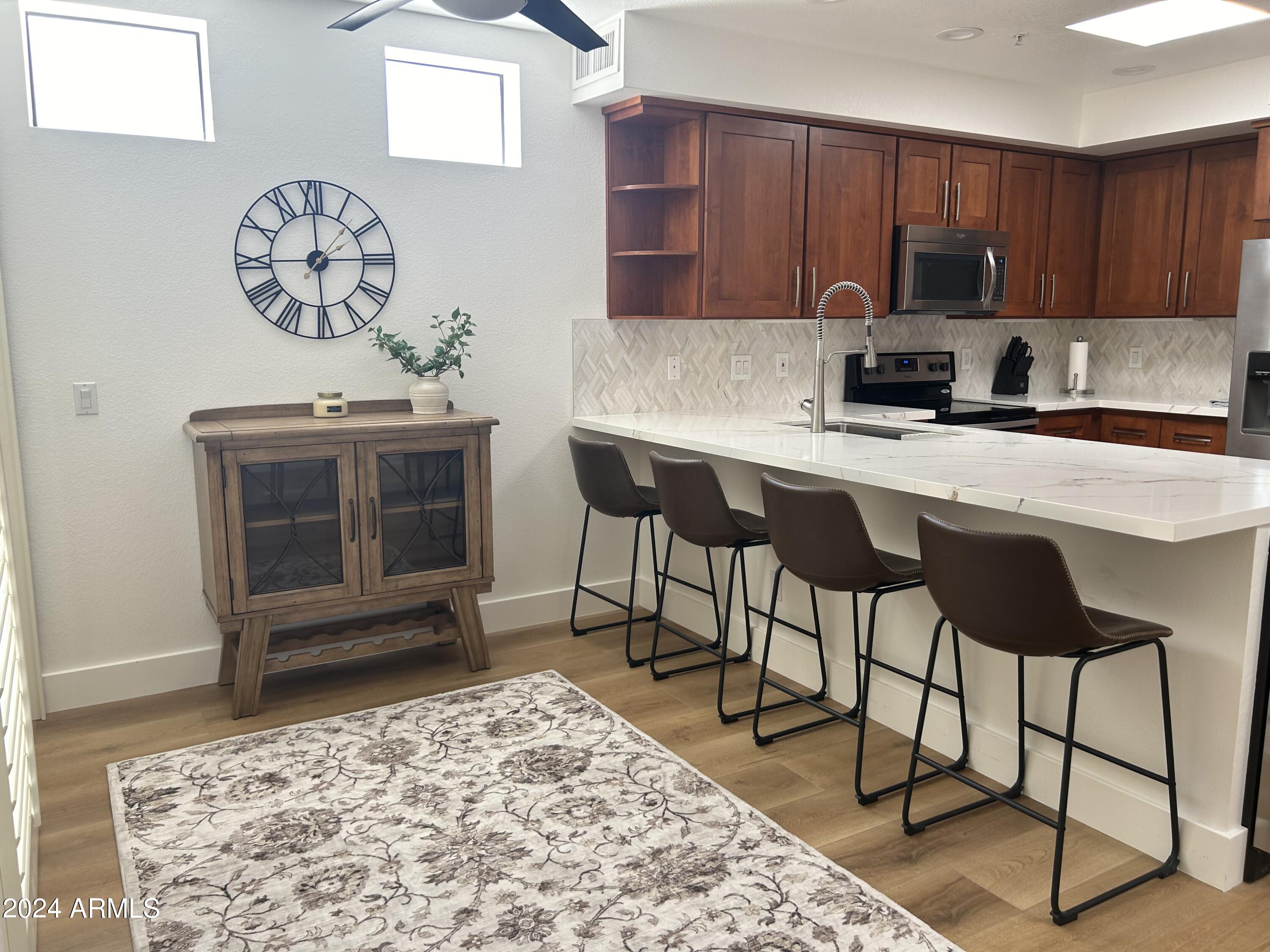7222 East Gainey Ranch Road, Unit 232 Scottsdale, AZ 85258 - Photo 13 of 40 BREAKFAST ROOM W ISLAND