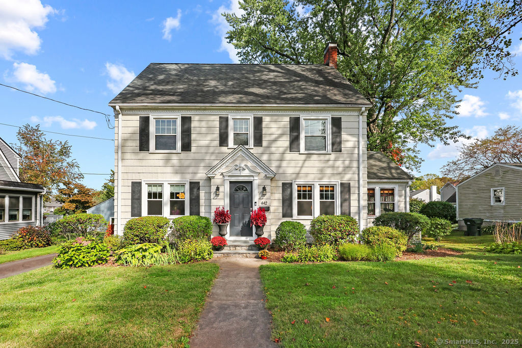 a front view of house with yard and green space