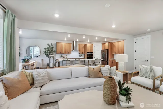 a view of a living room kitchen and a large window