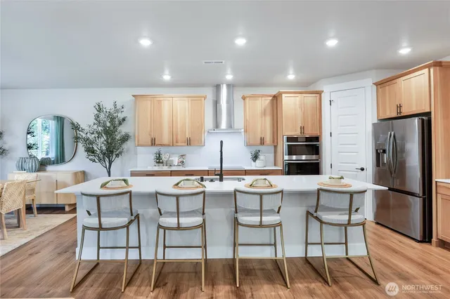 a kitchen with a table chairs refrigerator and cabinets