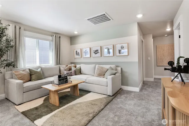 a living room with furniture and a large window