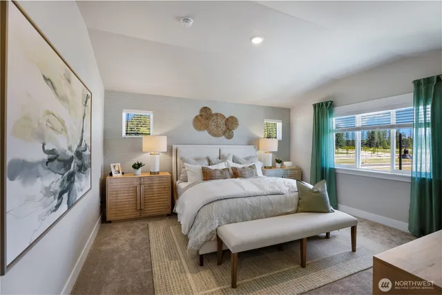 a bedroom with furniture and a large window