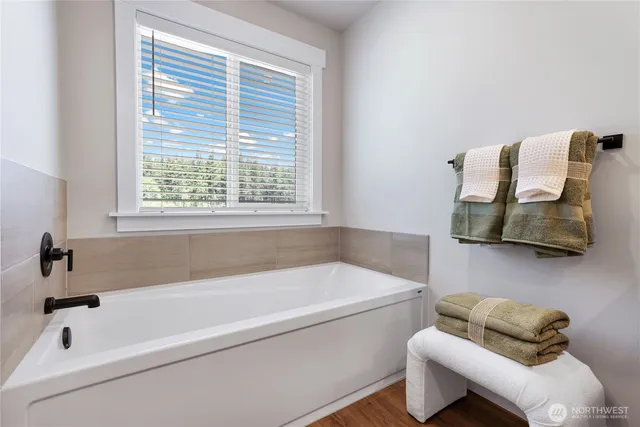 a bathroom with a bathtub and a window
