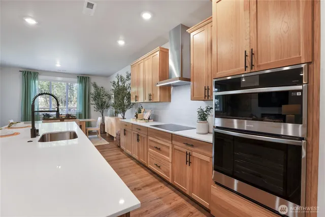 a kitchen with sink a microwave and cabinets