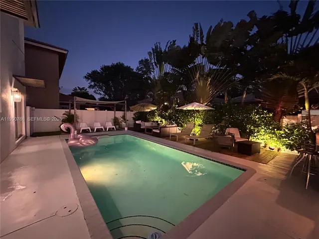 a view of a swimming pool and lounge chairs