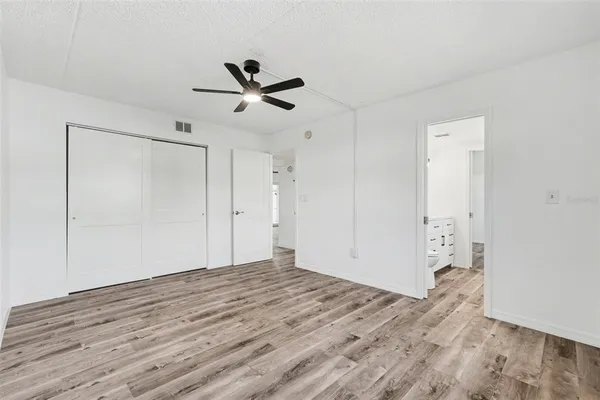a view of empty room with wooden floor