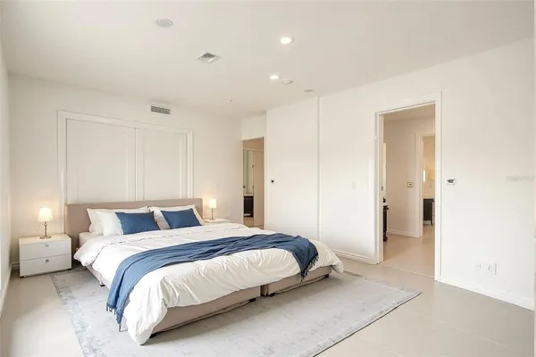 a view of empty room with wooden floor and ceiling fan