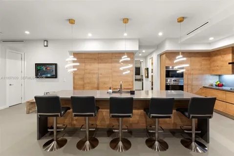 a living room with furniture and floor to ceiling windows
