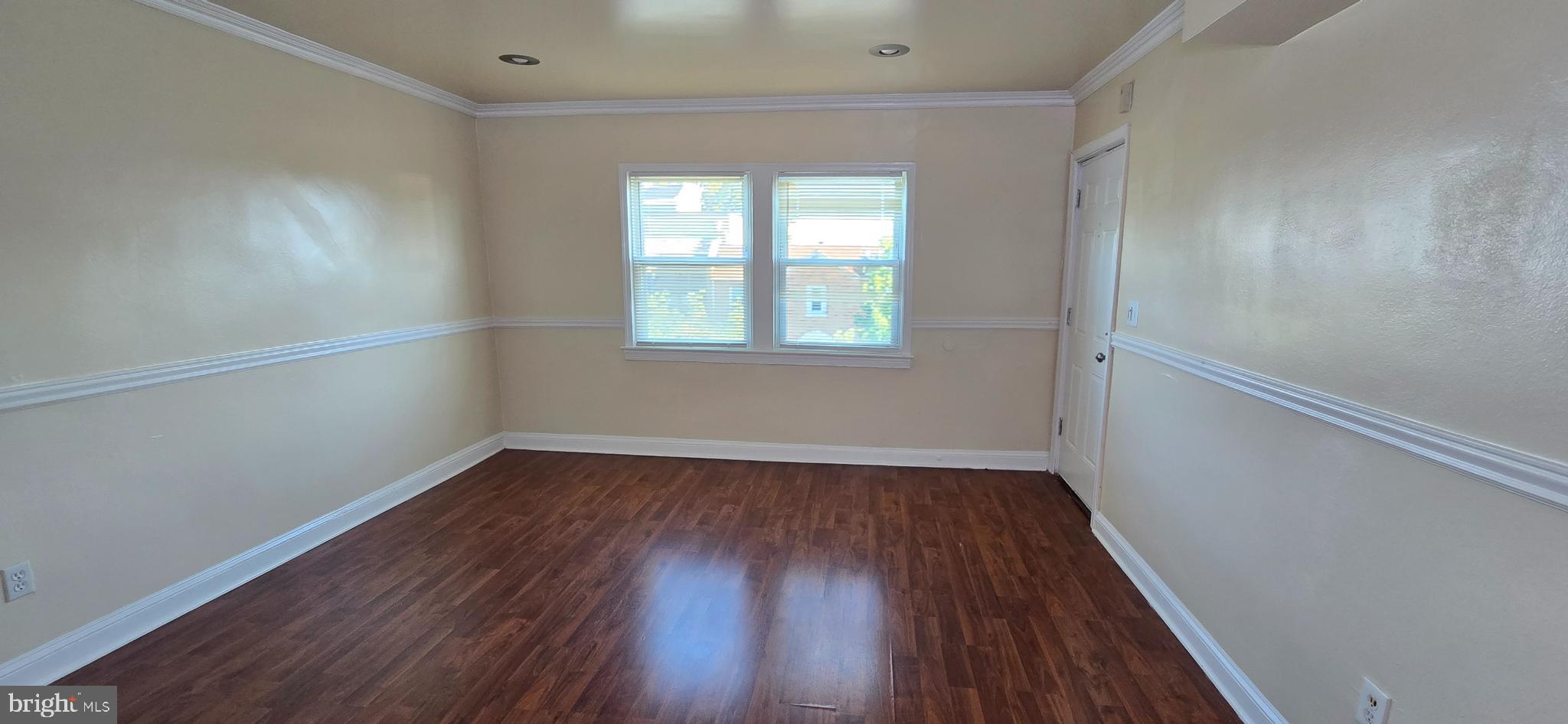 1255 Meigs Place Northeast, Unit 4 Washington, DC 20002 - Photo 6 of 15 an empty room with wooden floor and windows