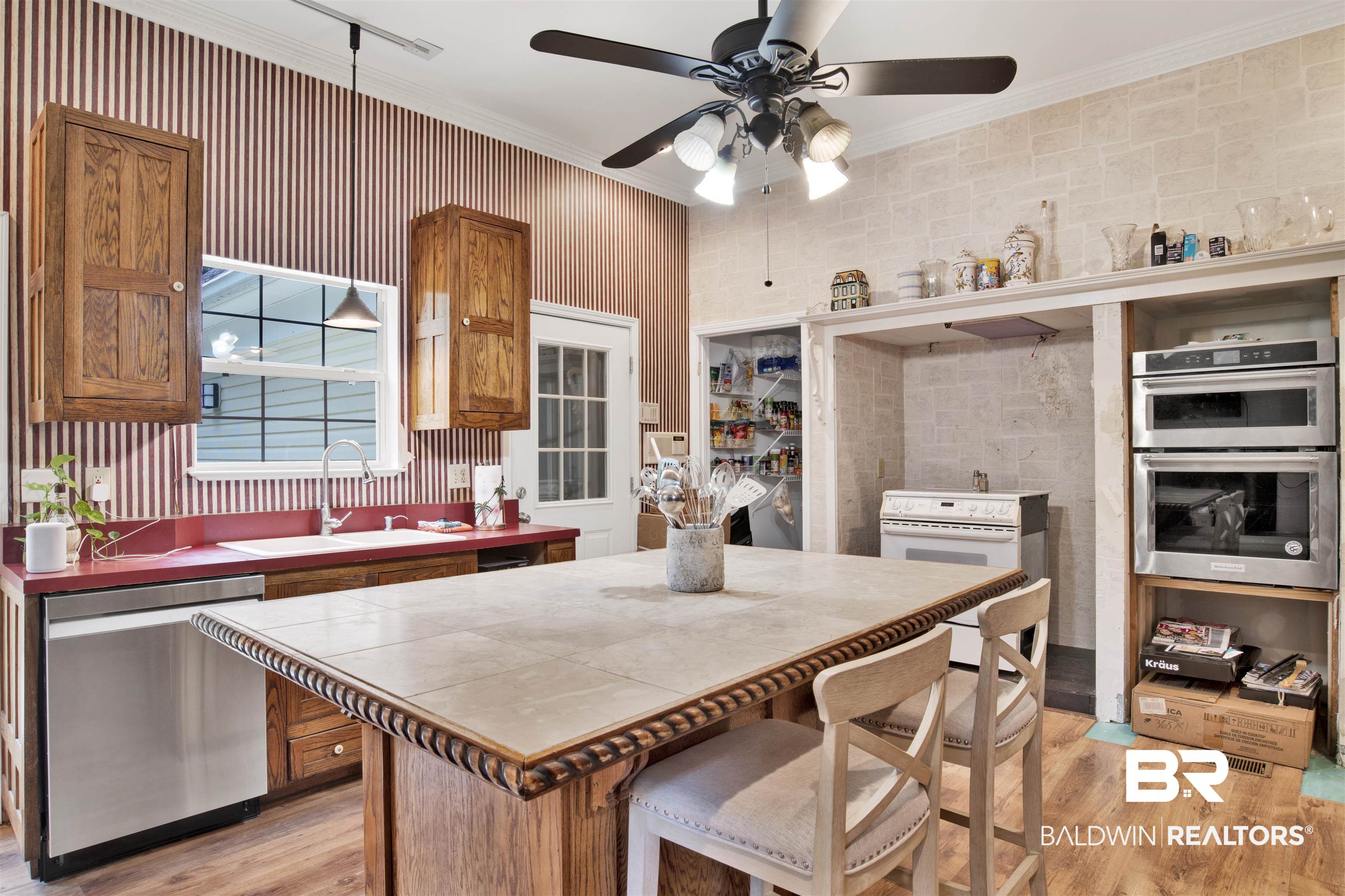 7641 Hitt Road Mobile, AL 36695 - Photo 11 of 29 Kitchen with crown molding, tile countertops, sink, ceiling fan, and appliances with stainless steel finishes