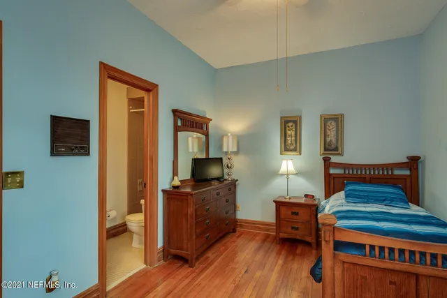 a bedroom with furniture and a wooden floor