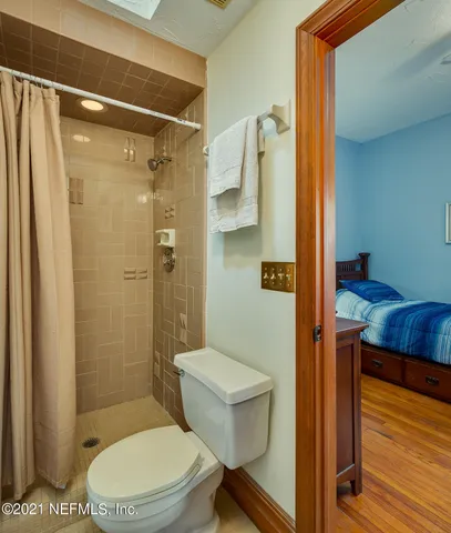 a bathroom with a toilet and a shower