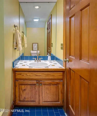 a bathroom with a granite countertop sink a large mirror and a bathtub