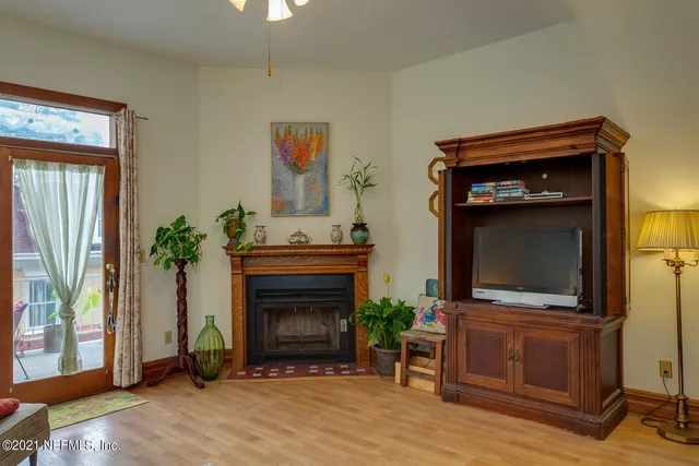 a living room with a fireplace and a flat screen tv