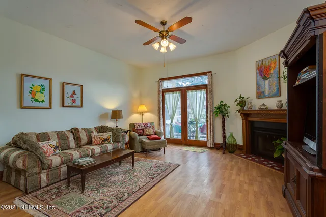 a living room with furniture a flat screen tv and a fireplace