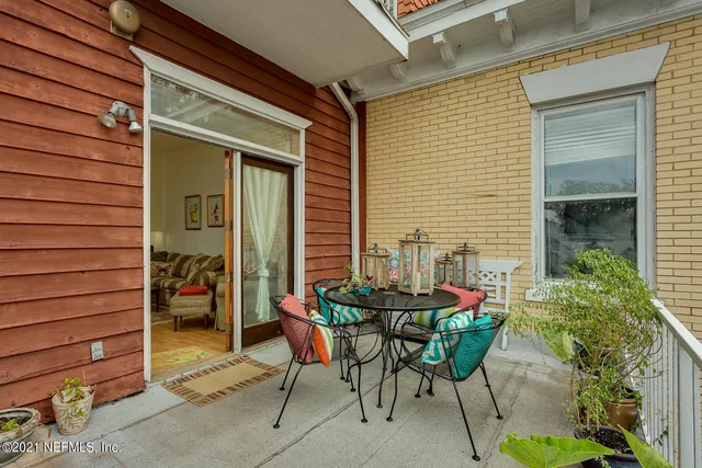 a view of a patio with table and chairs and potted plants