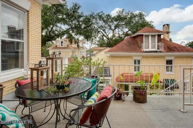 a view of house with a chairs and table in a patio