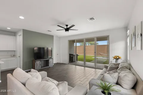 a living room with furniture tv and a large window
