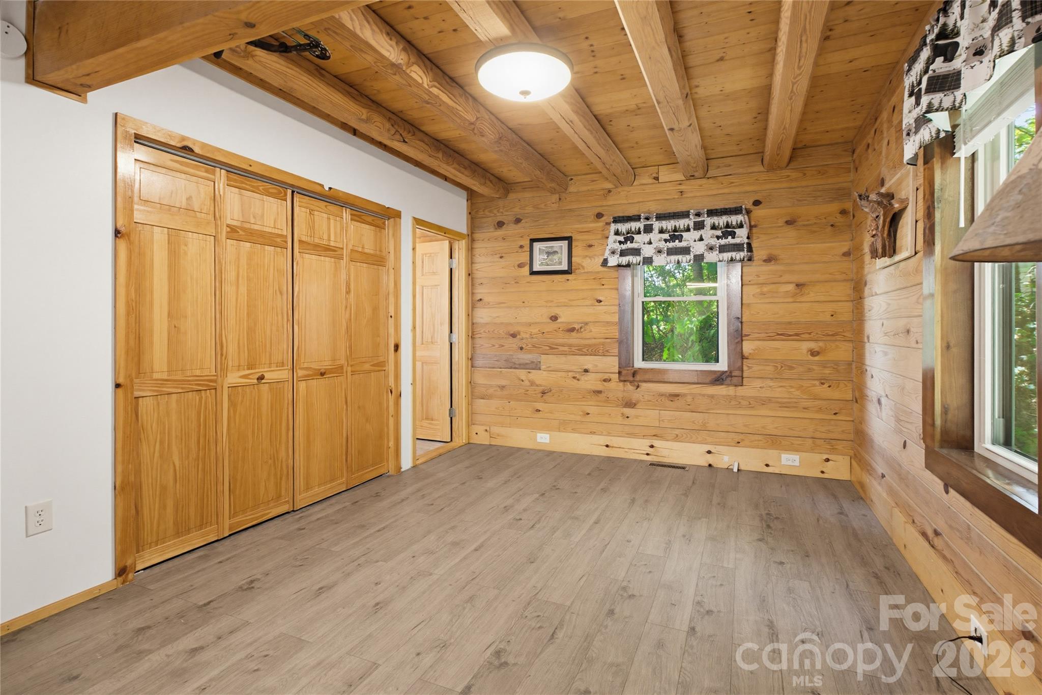 451 Rustic Ridge Drive Canton, NC 28716 - Photo 17 of 44 a view of a hallway with wooden floor and a window