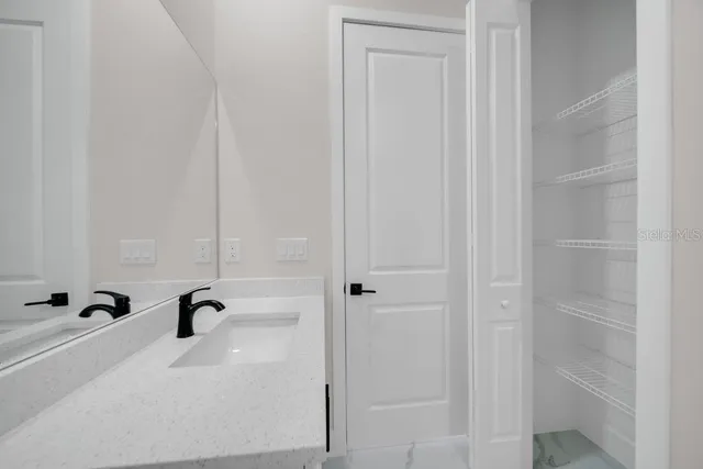 an empty room with a window and a ceiling fan