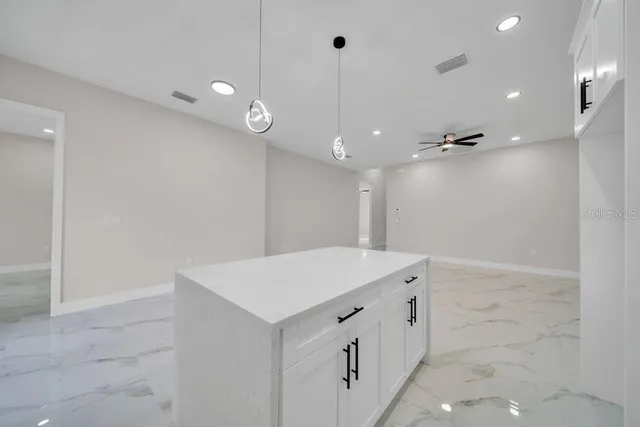 a view of a kitchen with a sink and a window