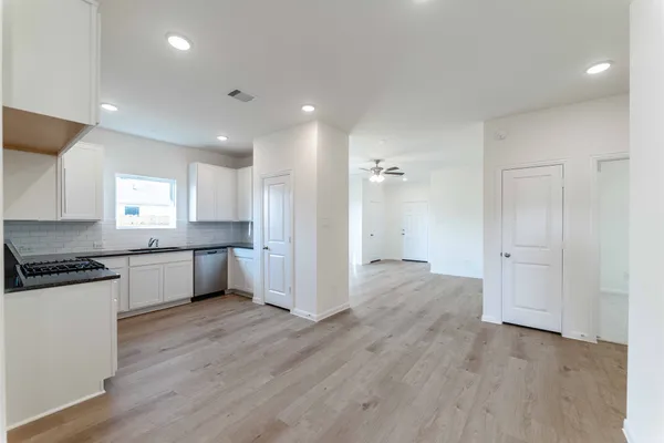a large kitchen with a lot of counter space and stainless steel appliances