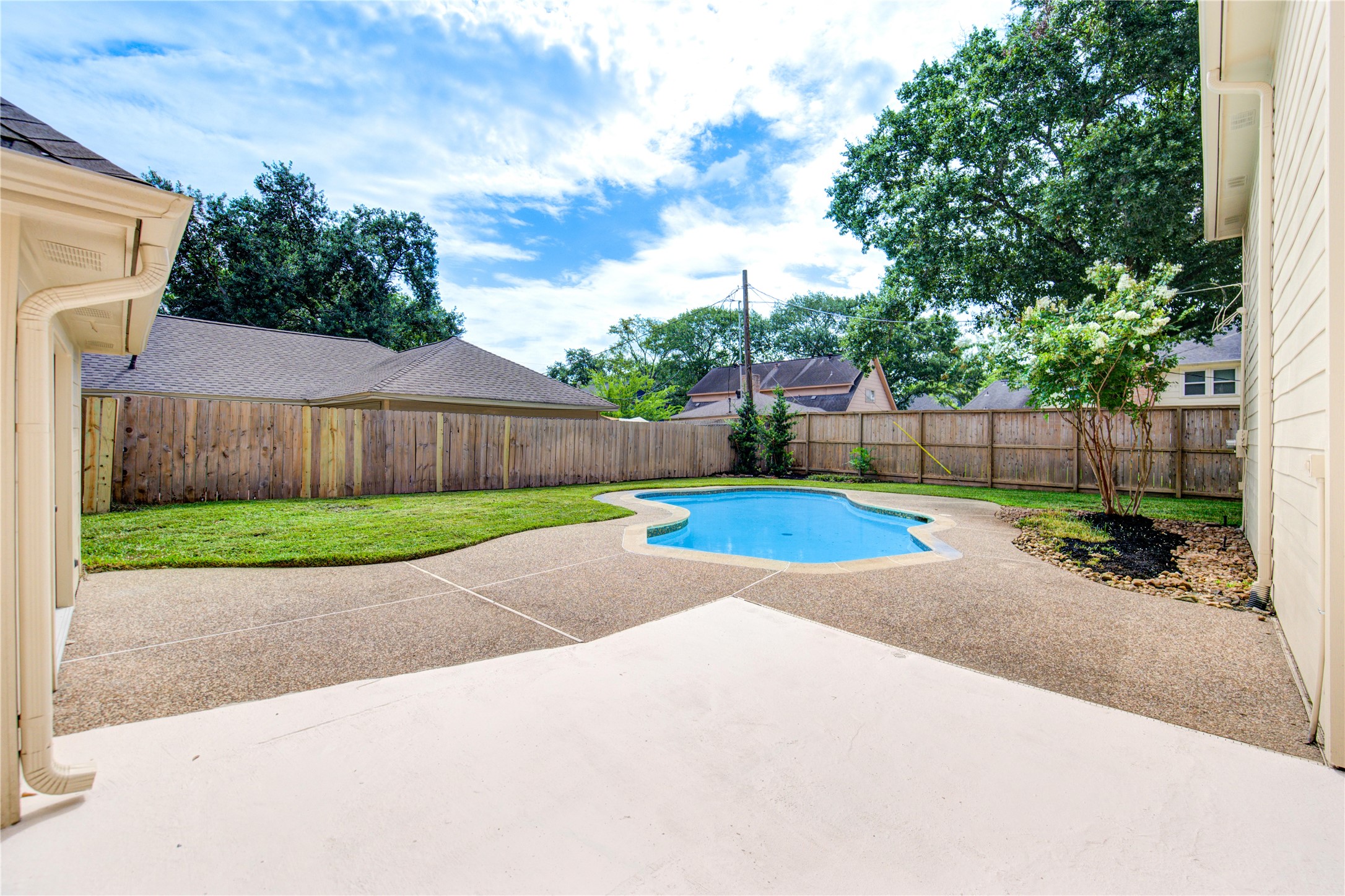 9115 Taidswood Drive Spring, TX 77379 - Photo 37 of 45 The fenced-in back yard has a really nice pool and pebble decking.
