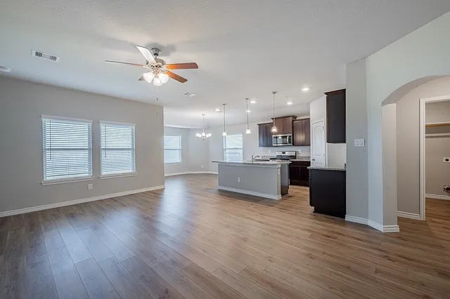 a view of kitchen with cabinets and wooden floor