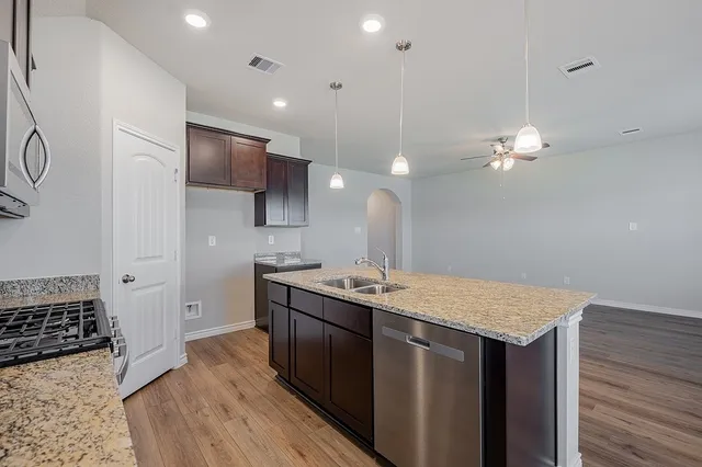 a kitchen with a sink a stove and refrigerator