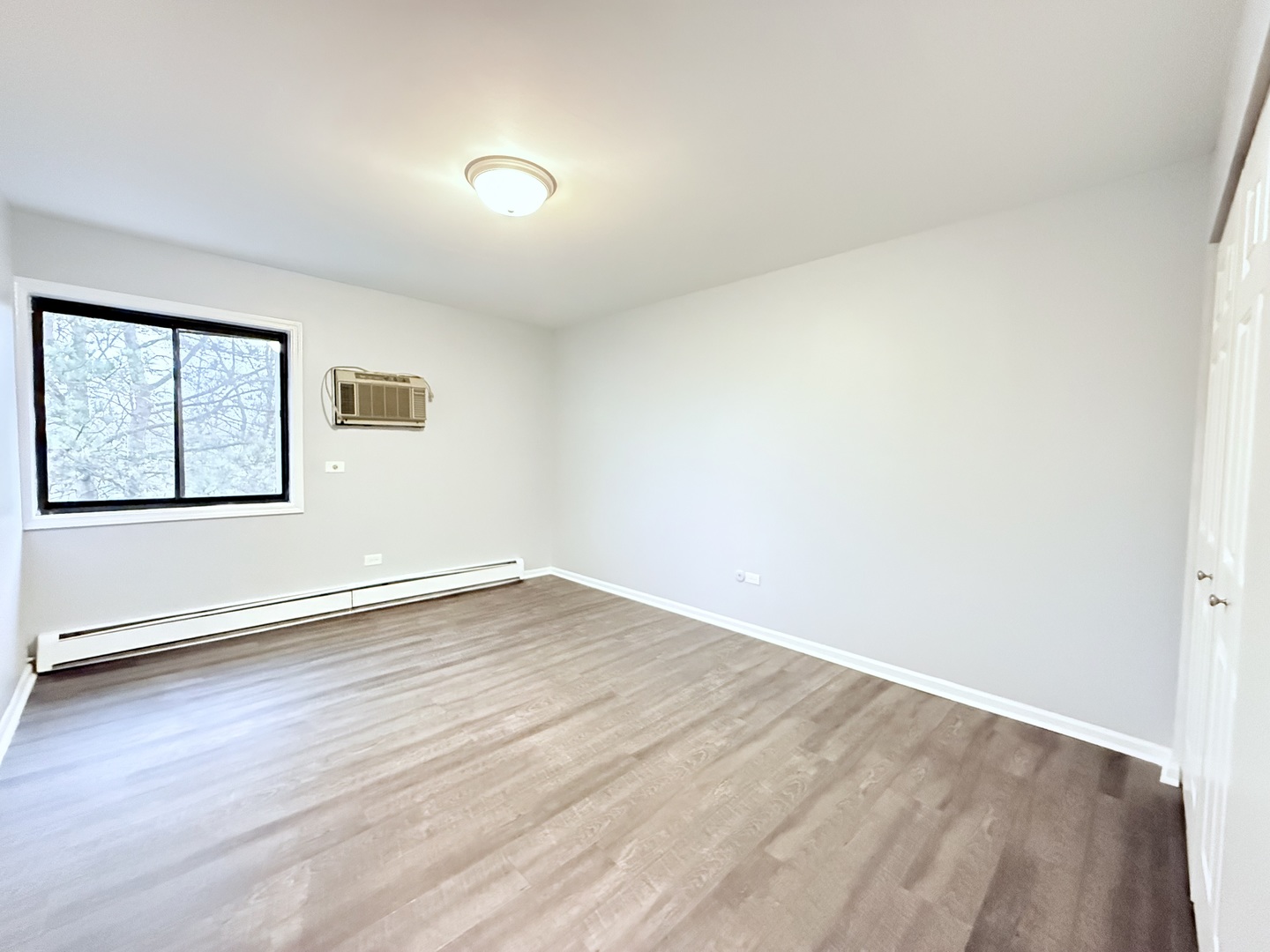 218 East Bailey Road, Unit M Naperville, IL 60565 - Photo 11 of 16 an empty room with wooden floor and windows