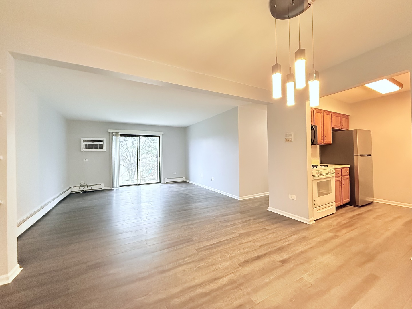 218 East Bailey Road, Unit M Naperville, IL 60565 - Photo 3 of 16 a view of a kitchen with wooden floor a ceiling fan and kitchen view