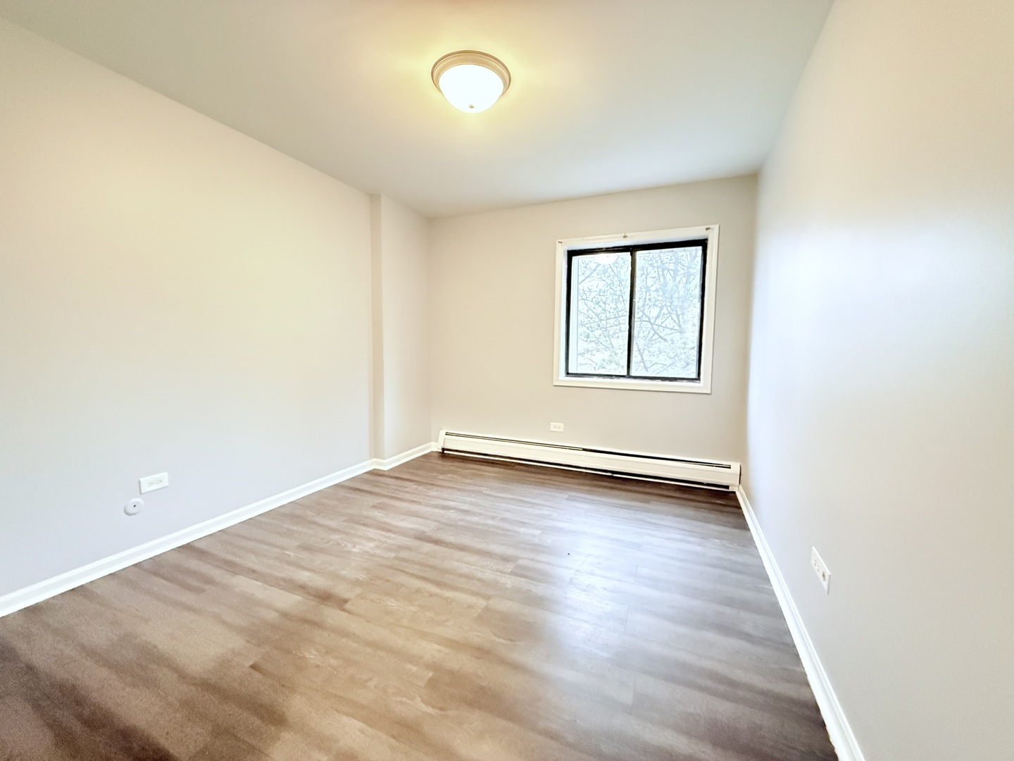 218 East Bailey Road, Unit M Naperville, IL 60565 - Photo 8 of 16 an empty room with wooden floor and windows