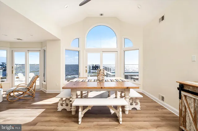 a dining room with furniture and wooden floor