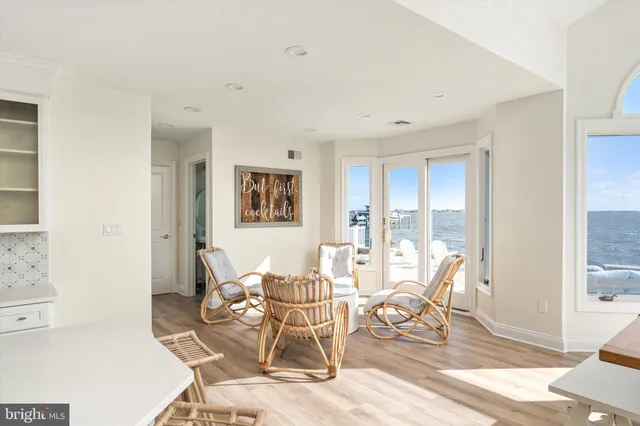a living room with a table chairs and entryway