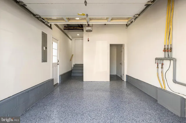 a living room with furniture and a view of kitchen