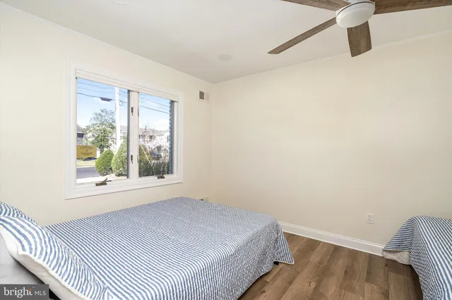 a bedroom with a bed and a ceiling fan