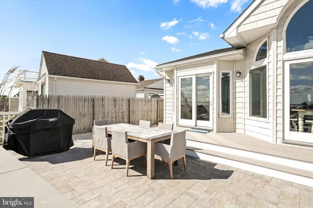 a balcony with chairs and a table