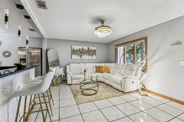 a view of a dining room with furniture and chandelier