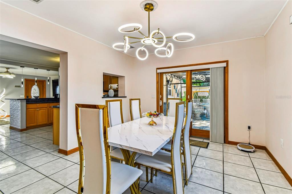 226 Maple Avenue Palm Harbor, FL 34684 - Photo 20 of 79 a view of a dining room with furniture and a chandelier