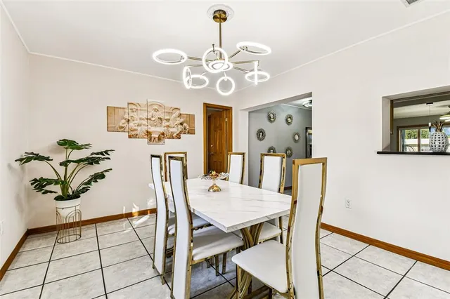 a bedroom with a large bed a flat tv screen and dresser