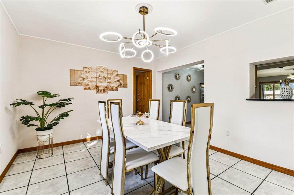 226 Maple Avenue Palm Harbor, FL 34684 - Photo 21 of 79 a view of a dining room with furniture and chandelier