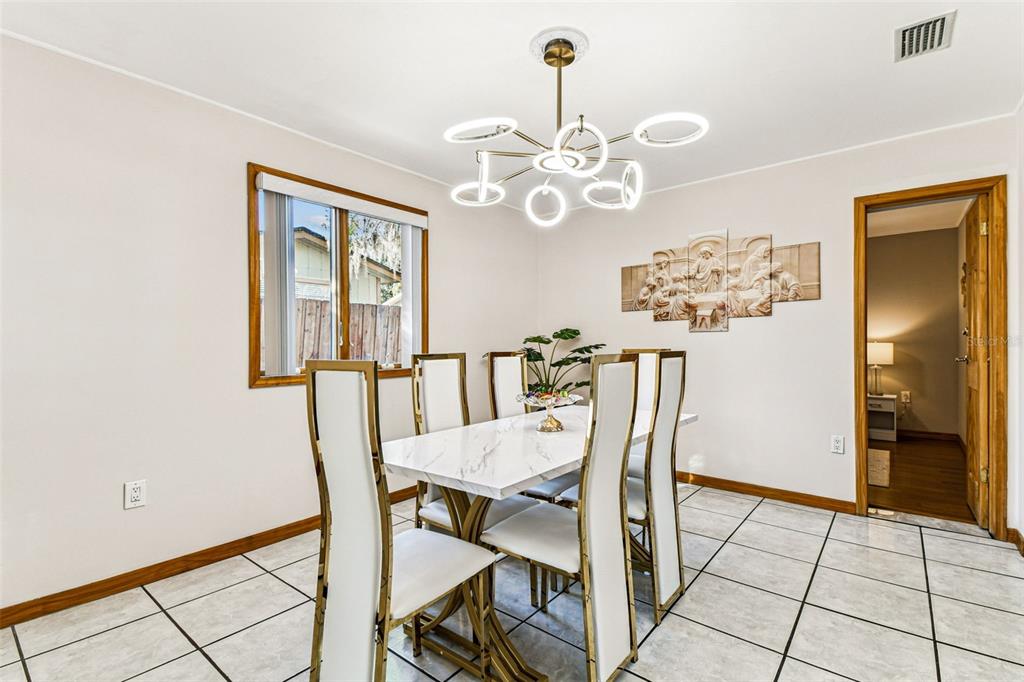 226 Maple Avenue Palm Harbor, FL 34684 - Photo 22 of 79 a view of a dining room with furniture and chandelier