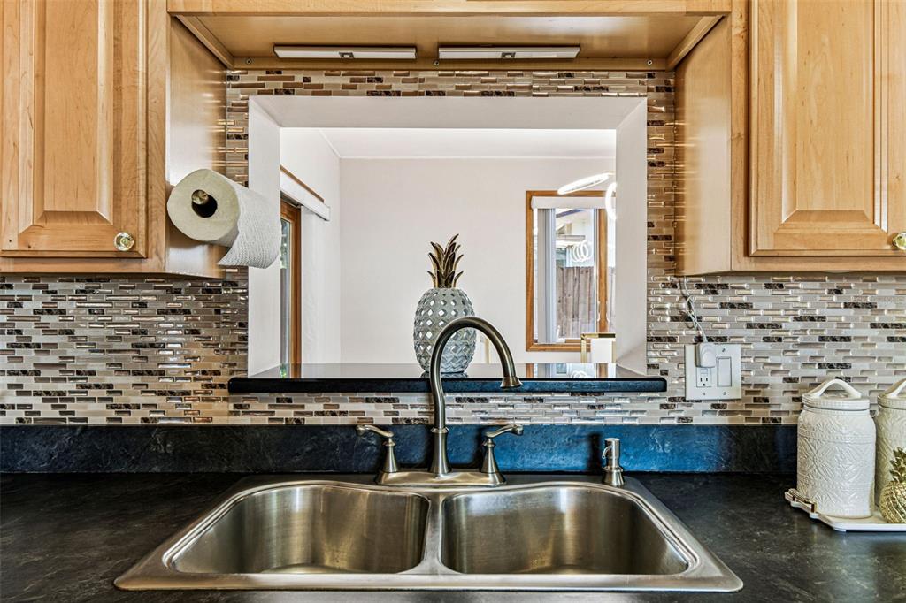 226 Maple Avenue Palm Harbor, FL 34684 - Photo 24 of 79 a kitchen with a sink and a stove