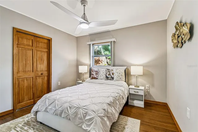 a bedroom with a large bed and a window