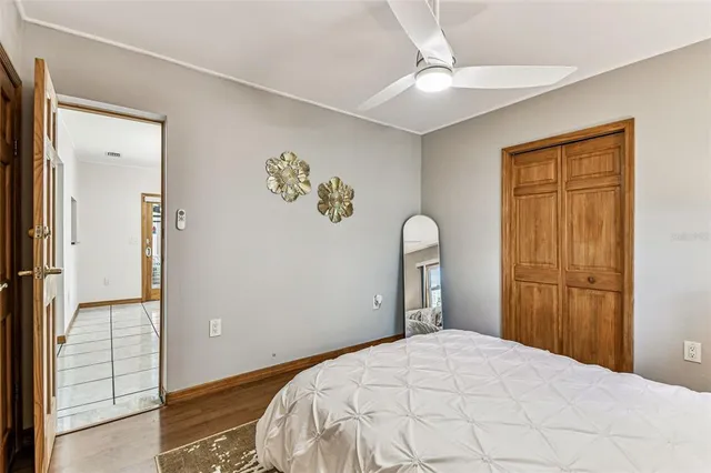 a bedroom with a large bed and a chandelier