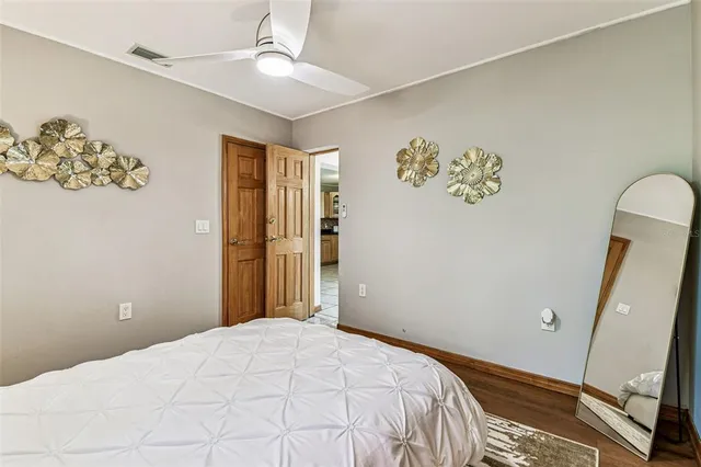 a bedroom with a large bed and a window